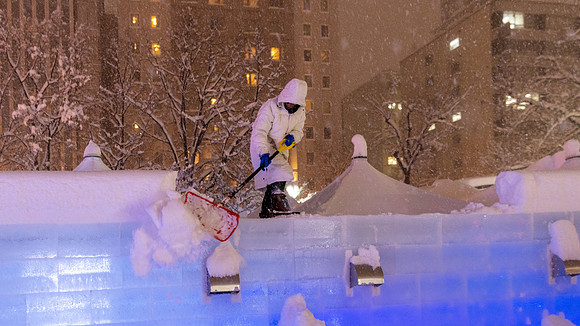 Clearing Snow from Sculpture