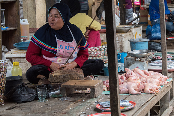 Lady Selling Chickens in Food Market. Swatting Flies.